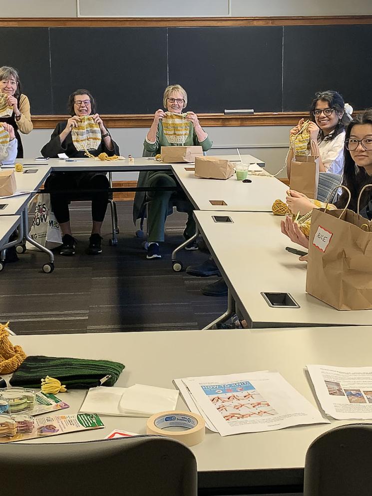 Members teaching Carleton students knitting